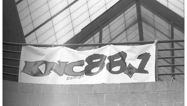 WKNC banner hanging from third floor railing of Witherspoon Student Center. Photo from 1999 Agromeck by Jamie Stevens.