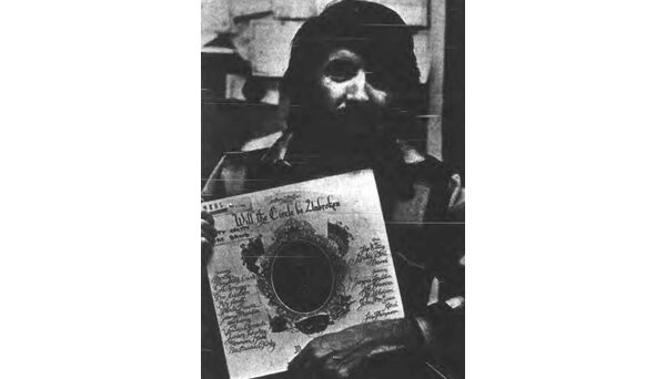John McEuen of The Nitty Gritty Dirt Band poses in the WKNC studio with his band's popular LP, Will the Circle Be Unbroken. Photo published in Jan. 12, 1979 Technician.