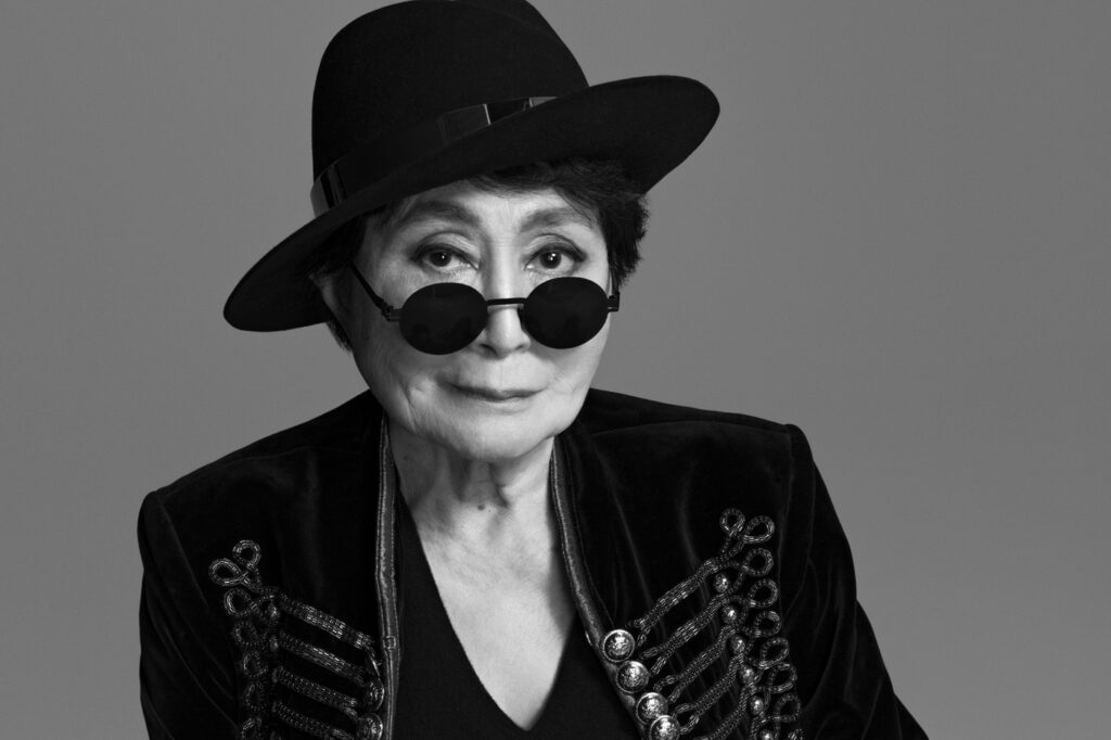 Yoko Ono posing for a publicity image in all black