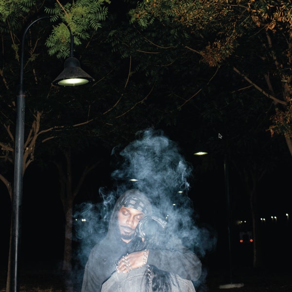 JPEGMAFIA LP! album cover. JPEGMAFIA standing outside beneath a streetlight and smoke surrounding him.