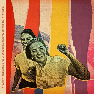 Cover art for A Touch of the Beat by Aly and AJ> Features a collage background and a picture of both of them smiling