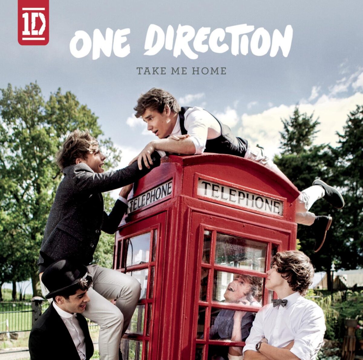 Album cover for "Take Me Home" by One Direction. Pictures the band members in and around a red telephone box.