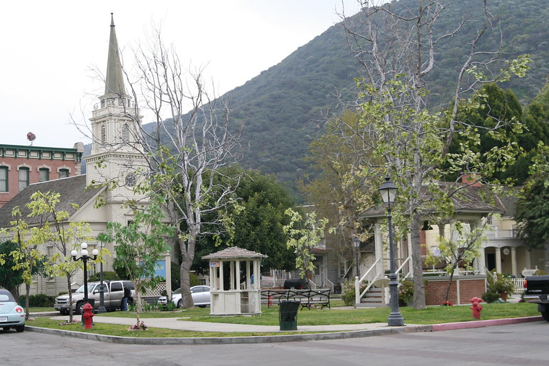 Photo of the town Gilmore Girls took place in. Features a mountain covered in green trees in the background, and a white church building in the foreground.