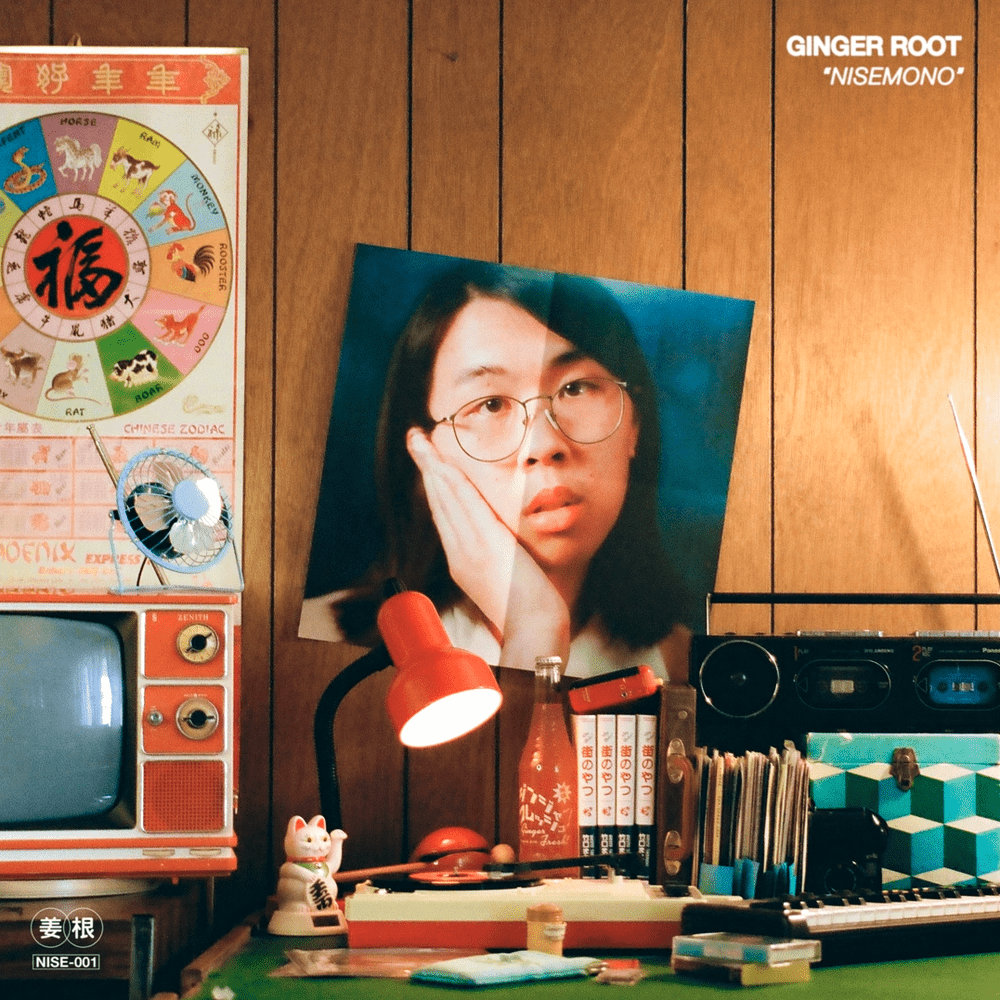 album cover for "Nisemono" by Ginger Root. Features a poster of ginger root on a wood-panel wall.