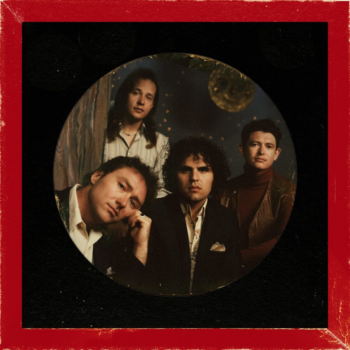 album cover for "Magic Hour" featuring the band posed in formal clothing, with a black circle border and red square border.