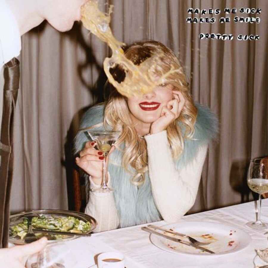 Cover art for Makes Me Sick Makes Me Smile by Pretty Sick. A photograph of a woman getting a drink thrown in her face. She has red lipstick on and is smiling and holding a cocktail. She is dressed in fancy clothes and appears to be at a dinner party.