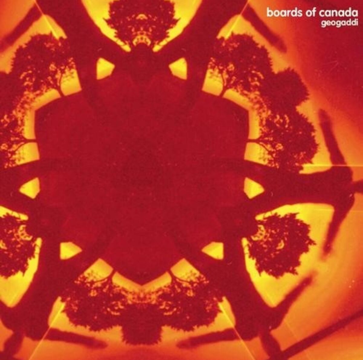 The album cover for "Geogaddi" by Boards of Canada. Features a kaleidoscopic red and orange image of a child jumping with trees in the background. It is refracted six times, so it appears hexagonal. The words "Boards of Canada, Geogaddi" appear in the top right corner