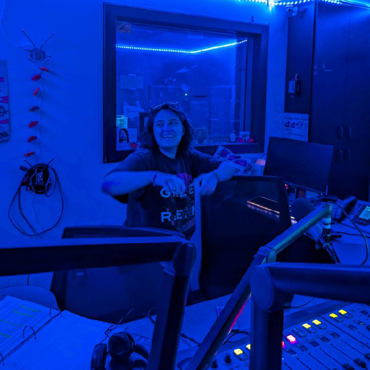 DJ in studio surrounded by blue light.