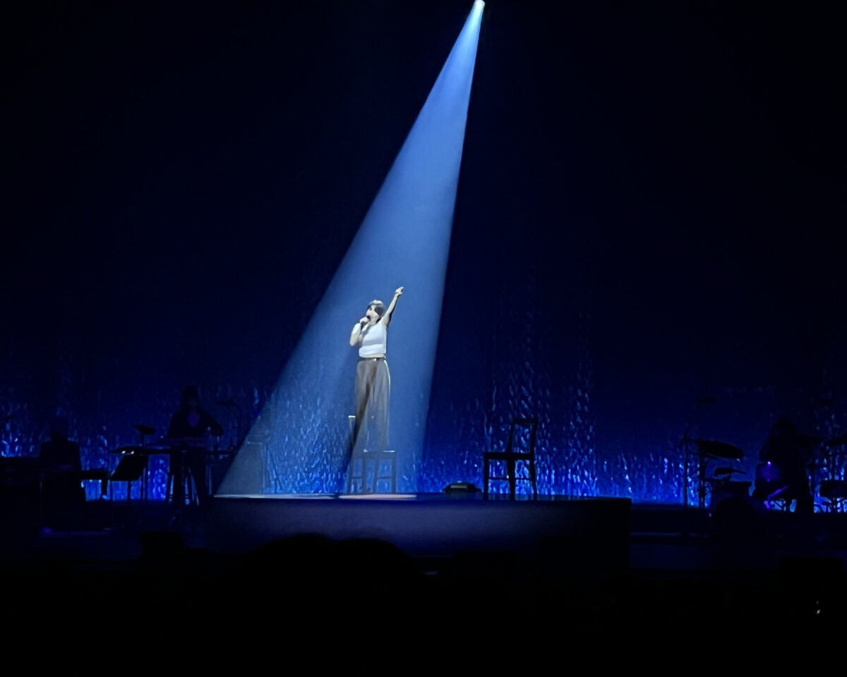 Mitski in concert with blue lighting