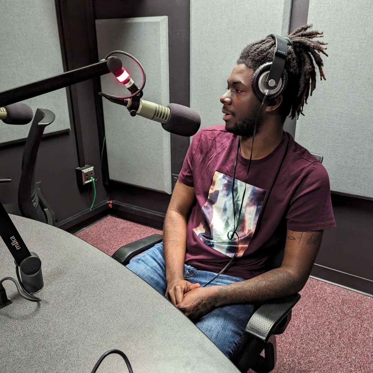 Black man speaking into a microphone.