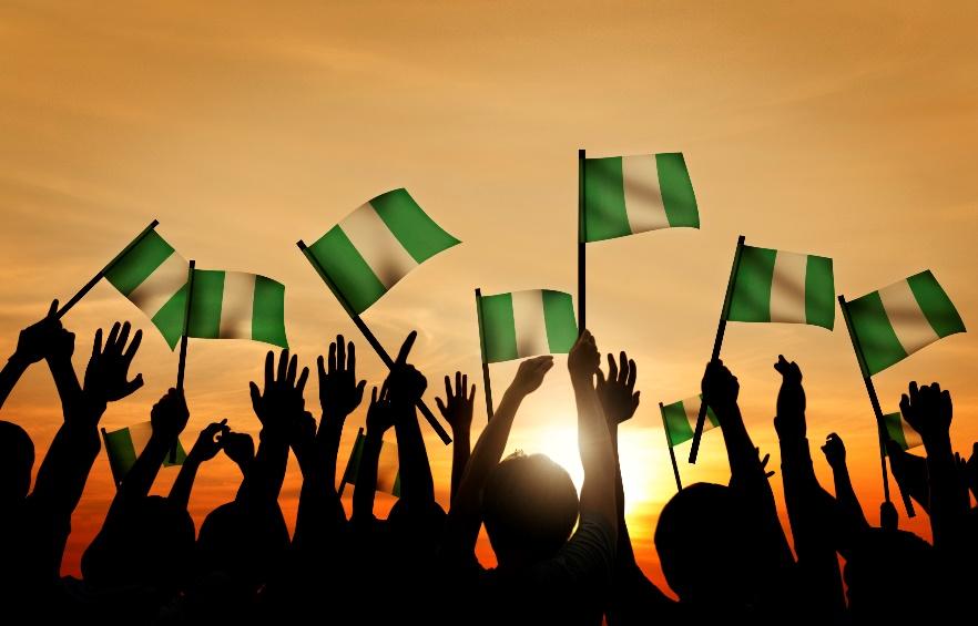 Multiple Nigerian flags held high