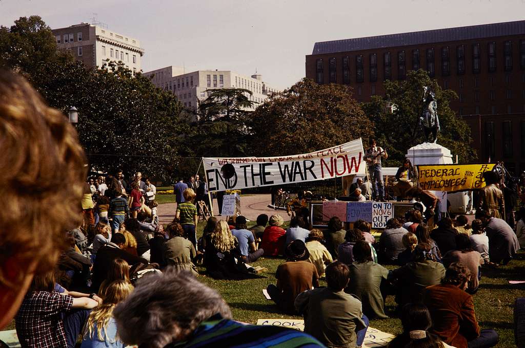 Group of people sitting on grass protesting