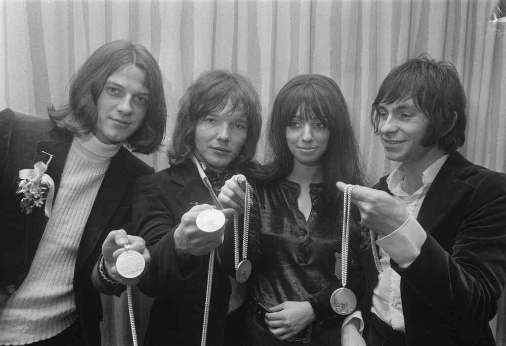 Black and white image of Shocking Blue showing off Silver Medal of Merit.