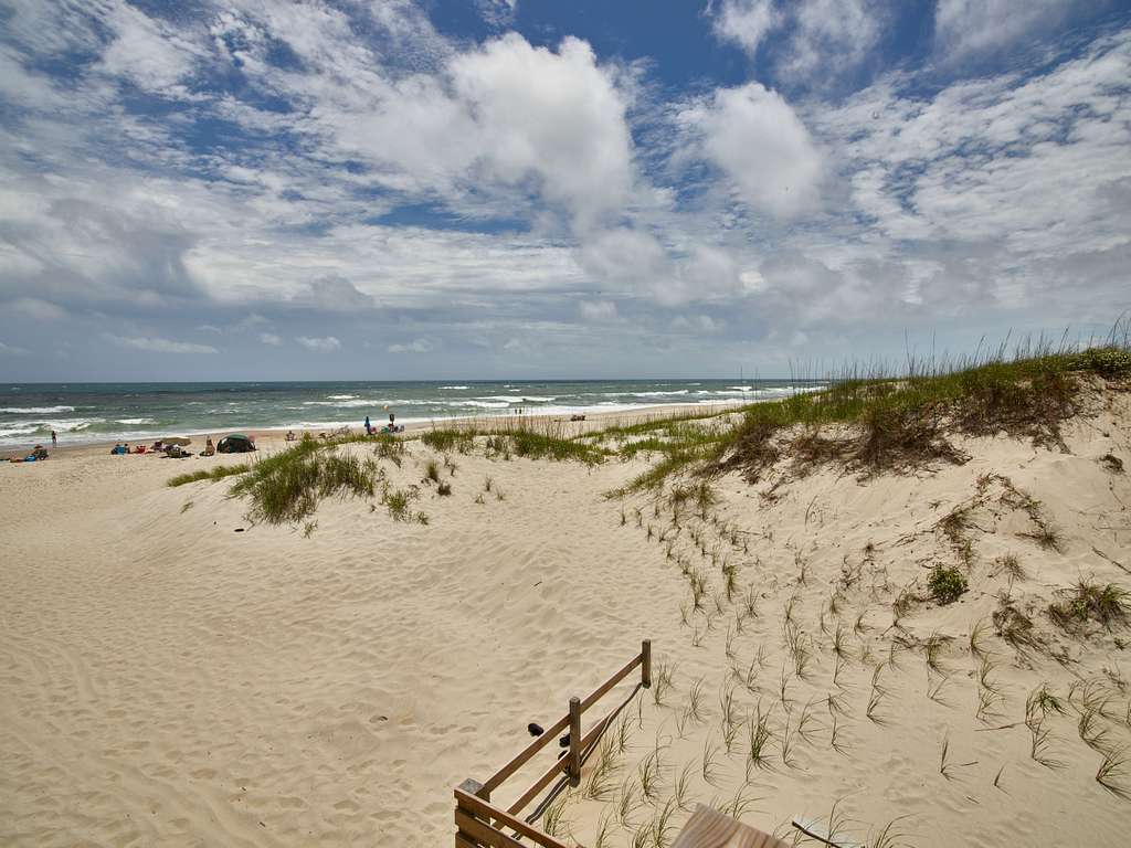 Yellow sand dunes by the blue green ocean