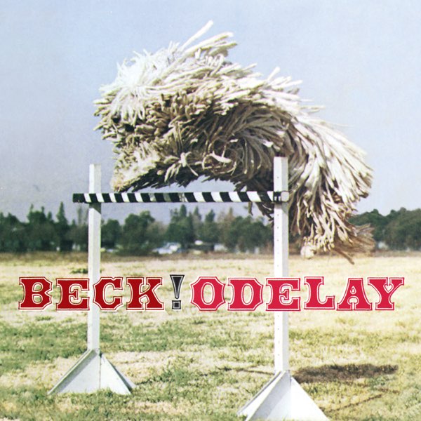 Album Cover of Odelay by Beck; a dog covered in fur to where all that is visible is its nose jumps over an agility hurdle in a large field