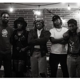 Five members of Survival Tactics standing in front of a brick wall with string lights above.