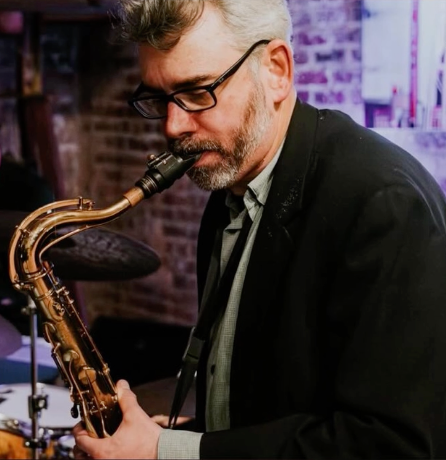 Man in glasses playing saxophone