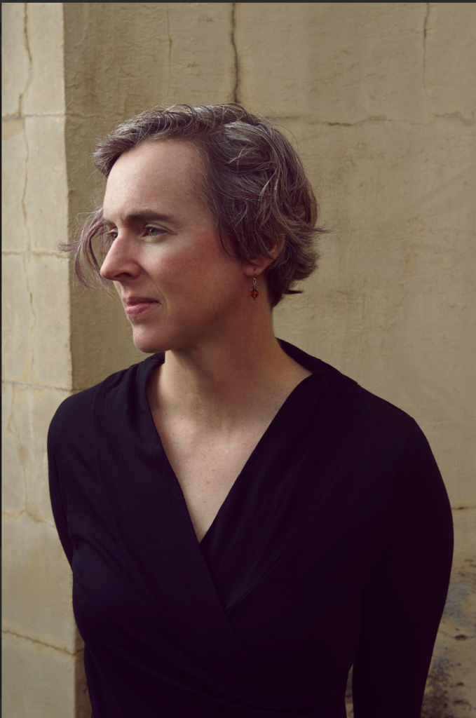 Headshot of woman in black facing to the left