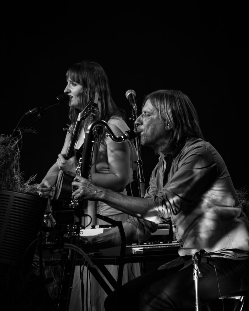 Madison Cunningham playing guitar and sings while Jesse Chandler plays bass clarinet.