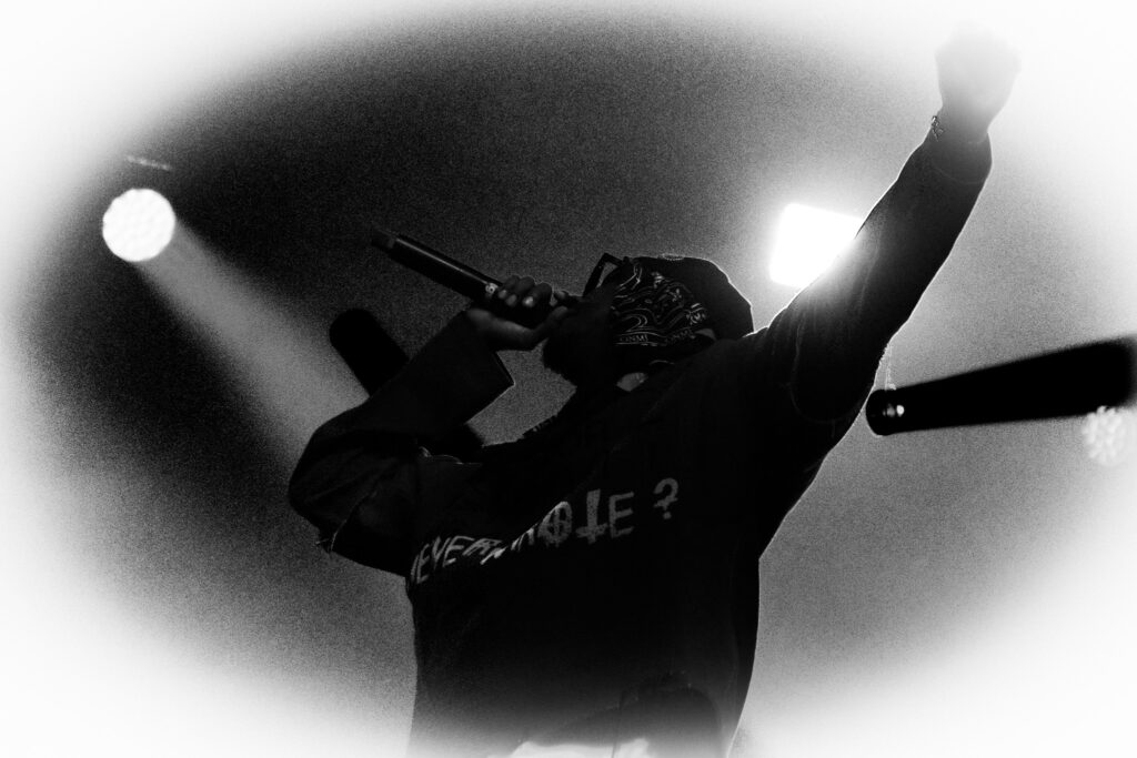 Black and white image of K CAMP with lights around him.