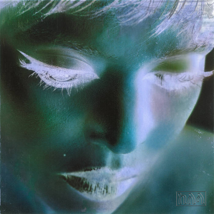 A photo seeminly done in some sort of negative, being an angled faceup of the singer Kelala.